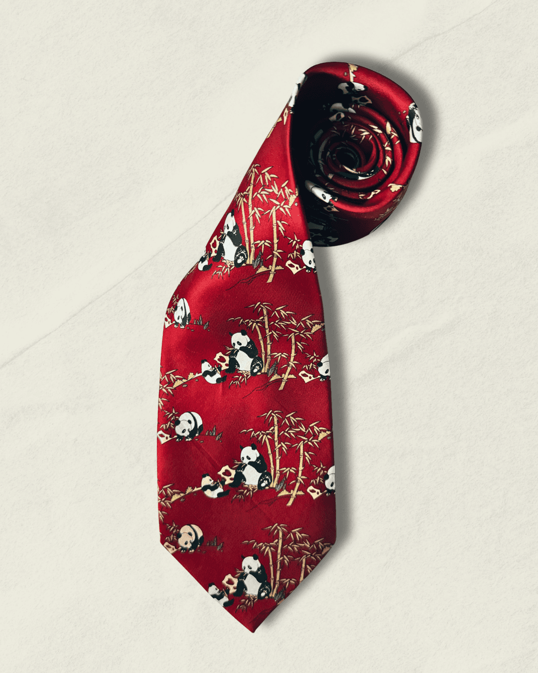 Vintage Giorgio Armani Cravatte tie in lacquer red, printed with pandas in a bamboo grove, styled over a white shirt and houndstooth jacket.