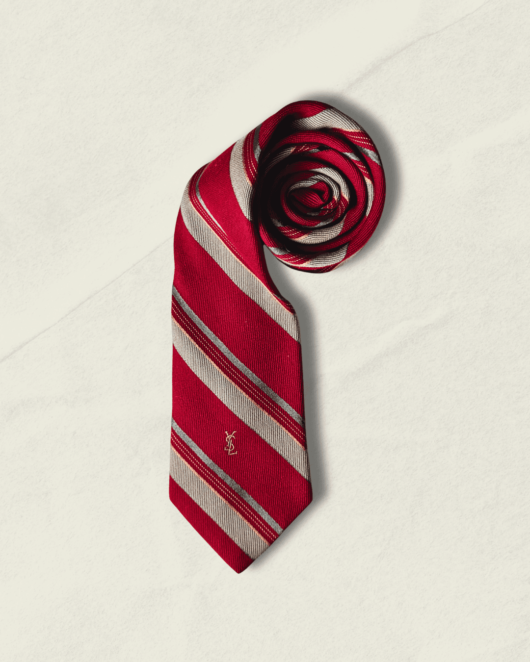 Vintage Yves Saint Laurent crimson repp-stripe tie with sand and sky-blue diagonal stripes, styled over a blue gingham shirt and houndstooth jacket.